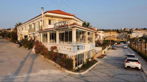 a house with a car parked in front of it at Alesya Otel in Çiftlikköyü