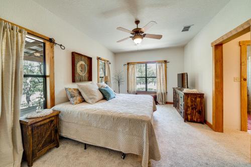 a bedroom with a bed and a ceiling fan at Swim, Hike and Unwind Serene Hill Country Retreat in Kerrville