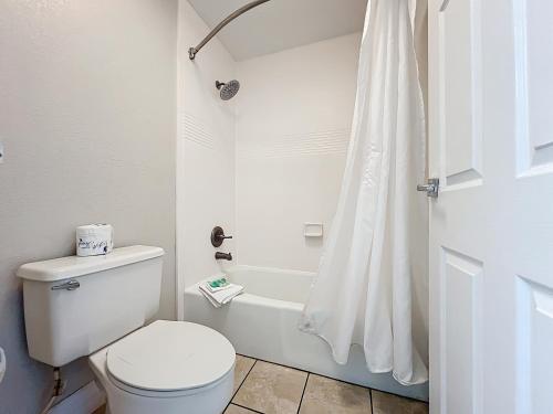 a white bathroom with a toilet and a shower at Stayable Lakeland in Lakeland