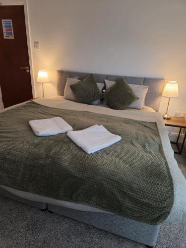 a bedroom with a large bed with two towels on it at The Park Lodge in Kinsale