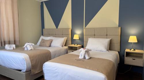 a hotel room with two beds with towels on them at Andari Hoteles in Arequipa
