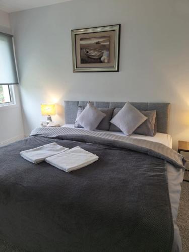 a bedroom with a bed with two towels on it at The Park Lodge in Kinsale