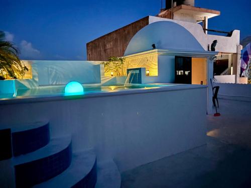 a building with a blue light on top of it at The Mermaid and The Pearl Boutique Hotel in Isla Mujeres