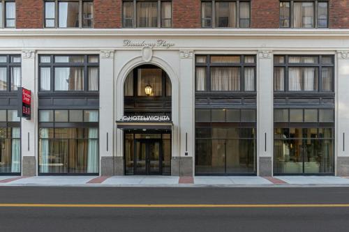a large building with an entrance to a store at AC Hotel by Marriott Wichita Downtown in Wichita
