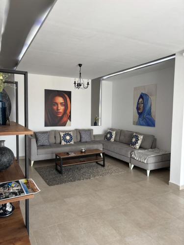 a living room with two couches and a table at Le Majorelle in La Marsa