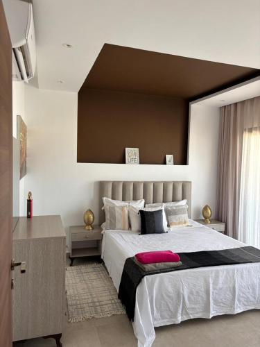 a bedroom with a large bed with a large window at Le Majorelle in La Marsa