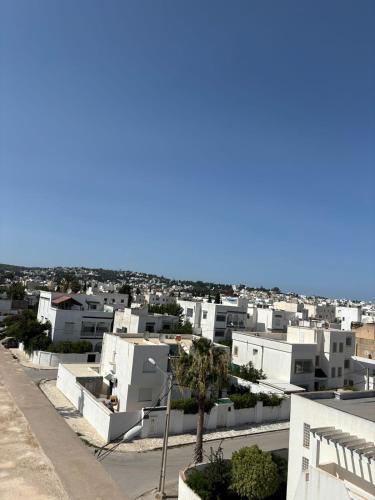 a view of a city with white buildings at Le Majorelle in La Marsa