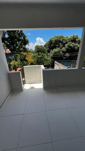 an empty room with a view of a building at Casa da Val in Conceição da Barra