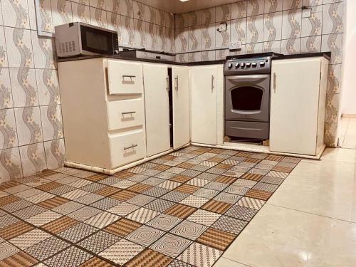 an empty kitchen with a stove and a refrigerator at Mountain View Villa in Freetown