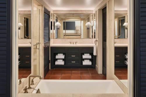 a bathroom with a tub and a large mirror at The Ritz-Carlton Bacara, Santa Barbara in Santa Barbara