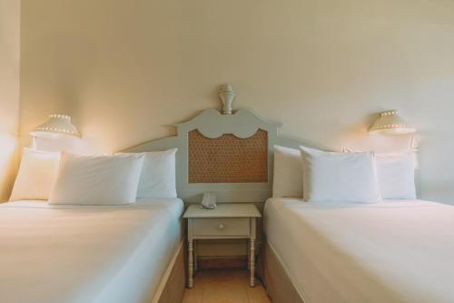 two beds sitting next to each other in a room at Iberostar Waves Costa Dorada - All Inclusive in San Felipe de Puerto Plata
