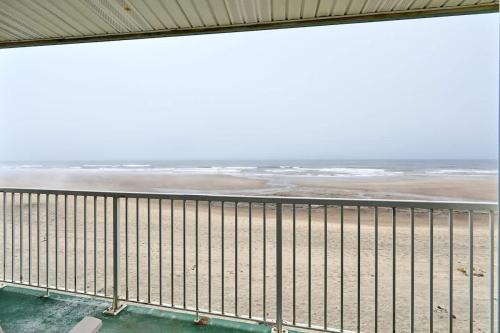 a balcony with a view of the beach at Fireplace Studio - Ground Level - Beach Access - Pool & Hot Tub in Lincoln City