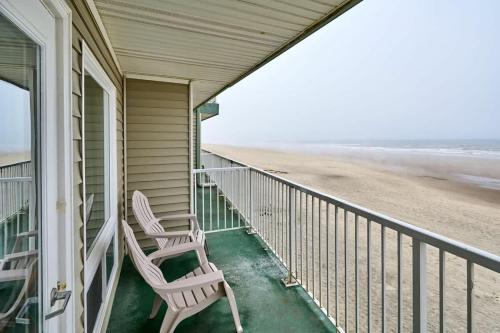 a porch with two chairs and the beach at Fireplace Studio - Ground Level - Beach Access - Pool & Hot Tub in Lincoln City