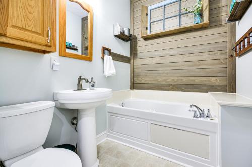 a bathroom with a tub and a sink and a toilet at 8 Mi to Dtwn Mt Airy Mtn-View North Carolina Home 