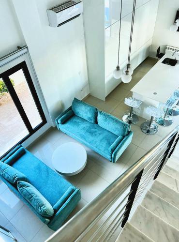 a living room with a blue couch and a table at Modern villa with a private pool in Polop