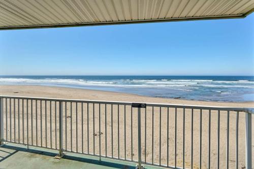 a view of the beach from a balcony at Ground Floor Studio - Easy Beach Access - Pool and Hot Tub in Lincoln City
