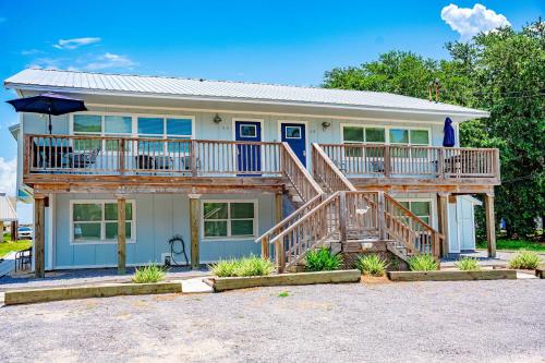 a house with a large deck on top of it at Coastal Condos on the Marsh 6B in Dauphin Island