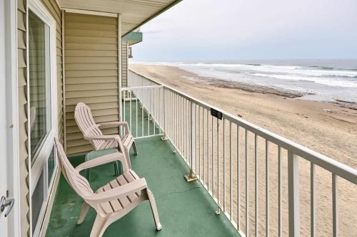 two chairs sitting on a porch next to the beach at Oceanfront Studio With Full Kitchen - Beach Access - Pool & Hot Tub in Lincoln City