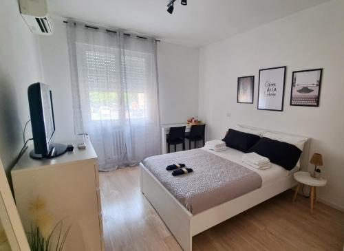 a bedroom with a bed and a flat screen tv at La Daiana in Imola