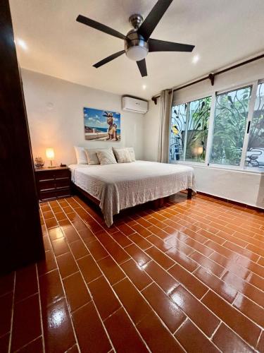 a bedroom with a bed and a ceiling fan at The Mermaid and The Pearl Boutique Hotel in Isla Mujeres