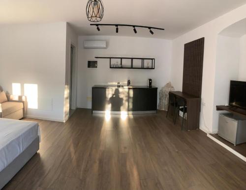 a bedroom with a bed and a desk in a room at Milo's Villa in Dhërmi