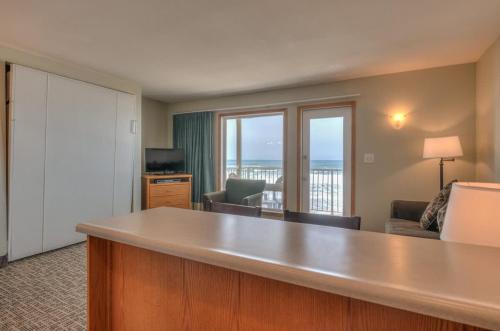 a hotel room with a view of a living room at Oceanfront One Bedroom Suite Stunning Views & King Bed in Lincoln City
