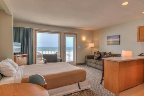 a hotel room with a bed and a living room at Oceanfront One Bedroom Suite Stunning Views & King Bed in Lincoln City