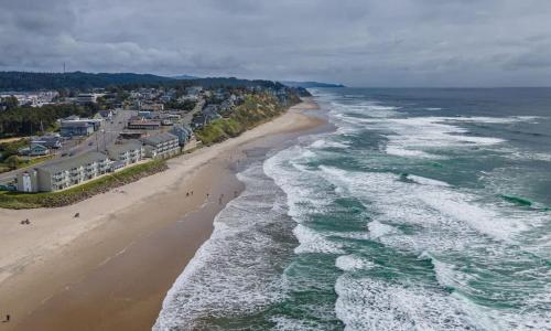 an aerial view of a beach and the ocean at Family Suite - Sleeps Six - Ocean View & Beach Access - Pool & Hot Tub in Lincoln City