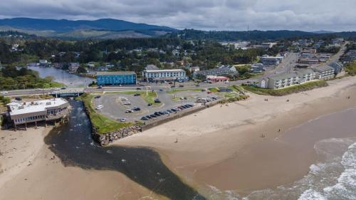 an aerial view of a beach next to the ocean at Family Suite - Sleeps Six - Ocean View & Beach Access - Pool & Hot Tub in Lincoln City