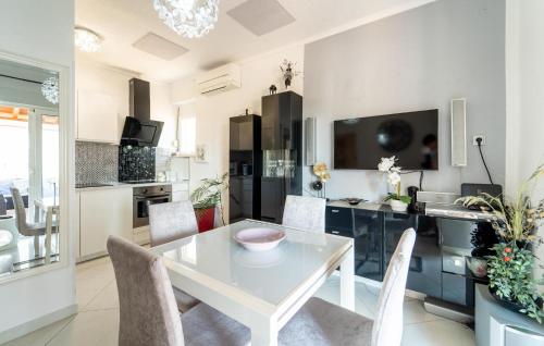 a kitchen and dining room with a table and chairs at Nice Apartment In Sali With Wifi in Sali