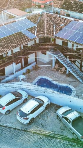 a group of cars parked in front of a building at Pousada Mar de Porto in Porto Seguro