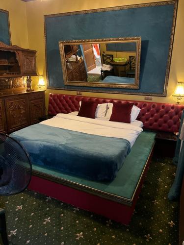 a bedroom with a bed with a mirror on the wall at Classic Love Story in Old Cluj II in Cluj-Napoca