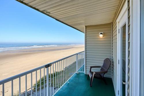 a porch with a chair and a view of the beach at Oceanfront Suite - Beach Access - Heated Pool and Hot Tub in Lincoln City