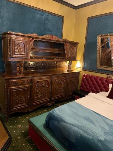 a bedroom with a large wooden dresser and a bed at Classic Love Story in Old Cluj II in Cluj-Napoca