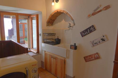 a small kitchen with a sink and a sink at Il Respiro del Borgo in Civitella Del Lago