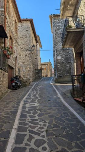 an empty cobblestone street in an old building at Il Respiro del Borgo in Civitella Del Lago