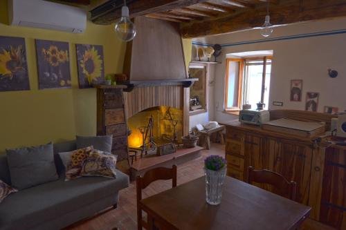 a living room with a couch and a table at Il Respiro del Borgo in Civitella Del Lago