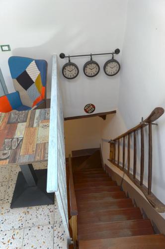 a room with a staircase with a bench and a table at Il Respiro del Borgo in Civitella Del Lago