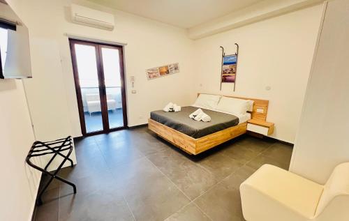 a bedroom with a bed and a chair in it at "Sweet Life" Casa Vacanze in Lipari