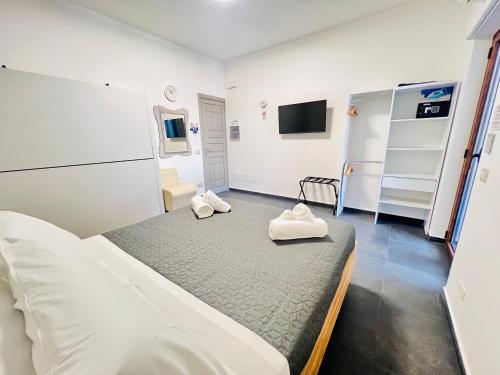 a bedroom with a bed with two towels on it at "Sweet Life" Casa Vacanze in Lipari