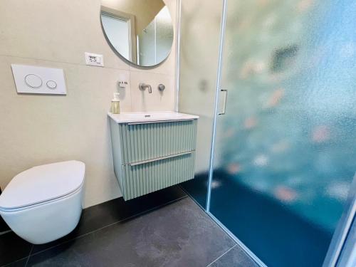 a bathroom with a toilet and a sink and a mirror at "Sweet Life" Casa Vacanze in Lipari