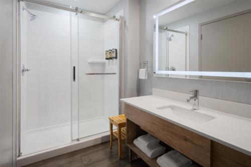 a bathroom with a sink and a shower at Best Western Premier Executive Residency Medicine Hat in Medicine Hat