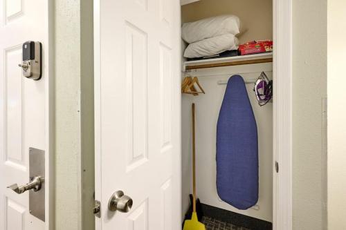 a door with a blue surfboard in a room at Oceanfront Suite - Sleeps 6 - Beach Access & Full Kitchen in Lincoln City