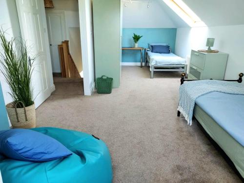 a bedroom with two beds and a chair in a room at Seaside Chill in Carrick