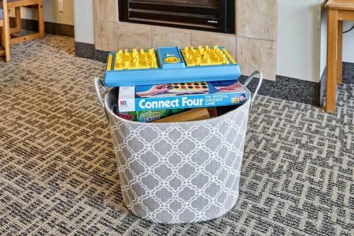 a trash can filled with games and books on a floor at Fireplace Suite With King Bed Full Kitchen Ocean Views - Heated Indoor Pool and Hot Tub in Lincoln City