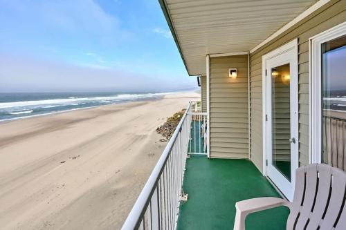 a house with a balcony with a view of the beach at Fireplace Suite With King Bed and Full Kitchen - Pool and Hot Tub Access in Lincoln City