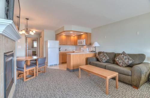 a living room with a couch and a kitchen at Stunning Ocean View Suite - Heated Indoor Pool and Hot Tub in Lincoln City