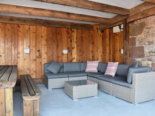 a living room with a couch and a table at Country Lodge in Soulby