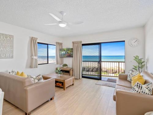 a living room with a view of the ocean at Palm Breeze - Hosted by Burleigh Letting in Gold Coast