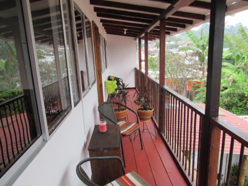 a balcony with chairs and tables on a house at Casa La Eliana in Salento